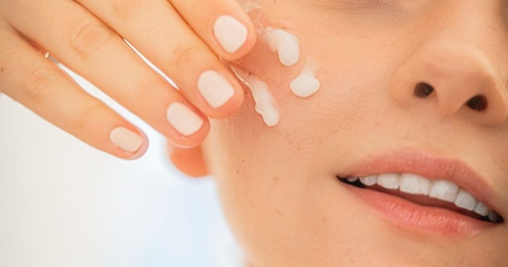 Close up of a woman applying moisturizer as part of a facial skincare routine in Dubai